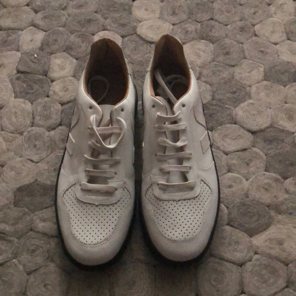 Veja white top low sneakers with black sole.